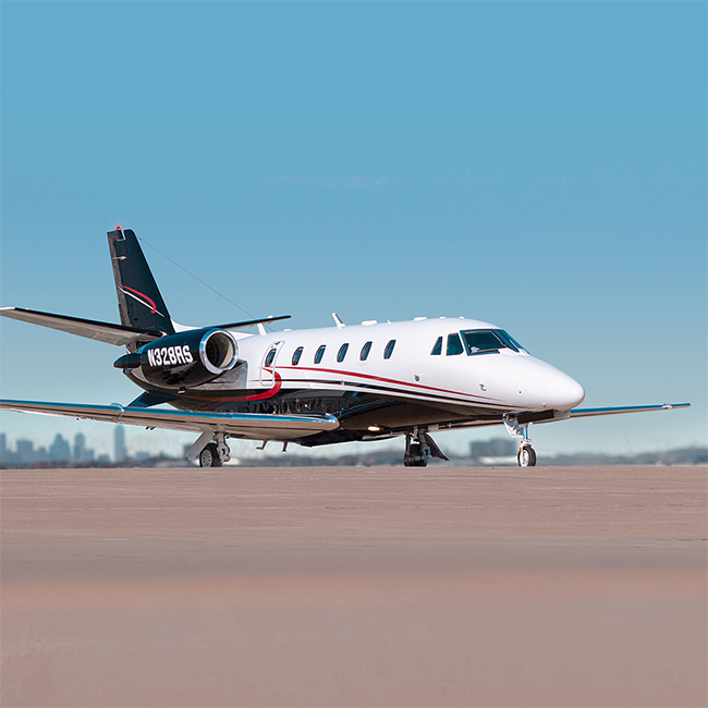 Citation XLS+ Private Jet. Based out of Dallas, Texas. White base paint with black underbelly and red stripes. Managed by Leviate Air Group.