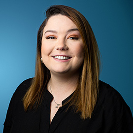 Corporate headshot of Kirsty Hunsley with blue background - Accounting & Office Assistant at Leviate Air Group